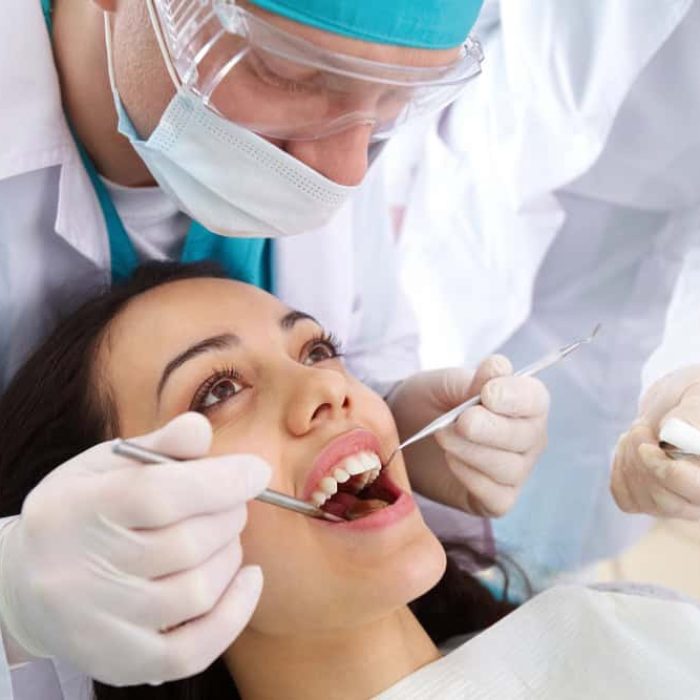 A young woman receiving dental treatment from a dentist at Molar House, emphasizing expert dental procedures.