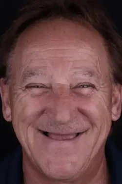 Smiling man with bright teeth, happy expression, close-up portrait for dental care.