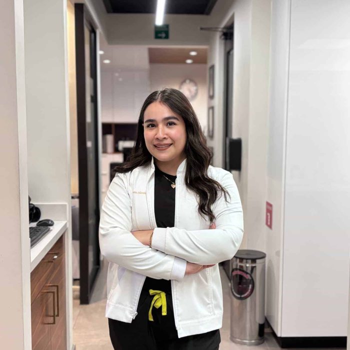 Friendly female dental professional at Molar House dental clinic smiling confidently.